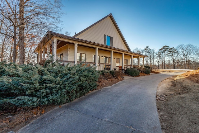 view of property exterior featuring covered porch