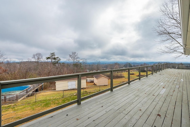 wooden terrace featuring a lawn