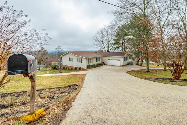 view of front of home featuring a garage and a front lawn