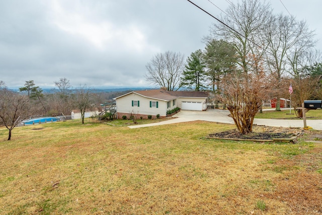 view of front of property featuring a garage and a front lawn