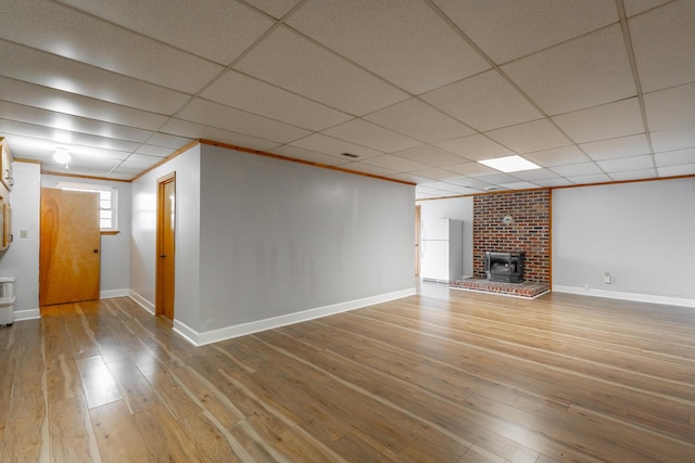 unfurnished living room featuring hardwood / wood-style flooring, a paneled ceiling, and crown molding