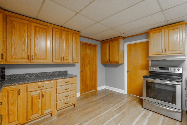 kitchen with a paneled ceiling, black microwave, dark stone countertops, stainless steel electric range, and light hardwood / wood-style flooring