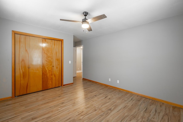 unfurnished bedroom with light hardwood / wood-style floors, a closet, and ceiling fan