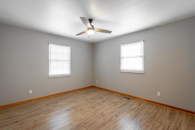 unfurnished room with ceiling fan and light wood-type flooring