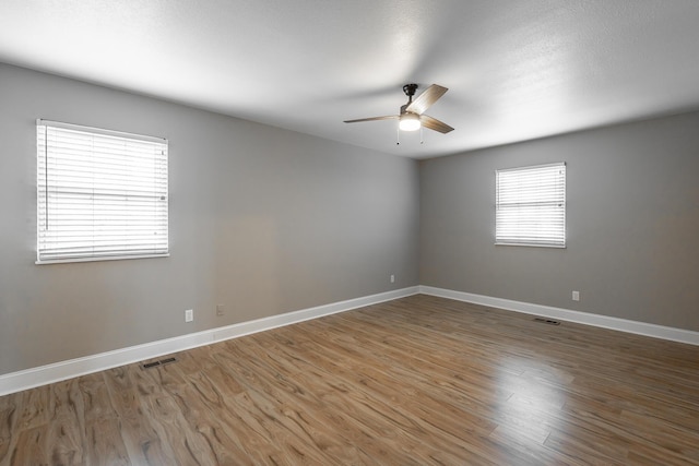 unfurnished room with hardwood / wood-style floors and ceiling fan