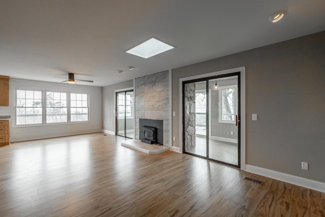 unfurnished living room with ceiling fan and light hardwood / wood-style floors