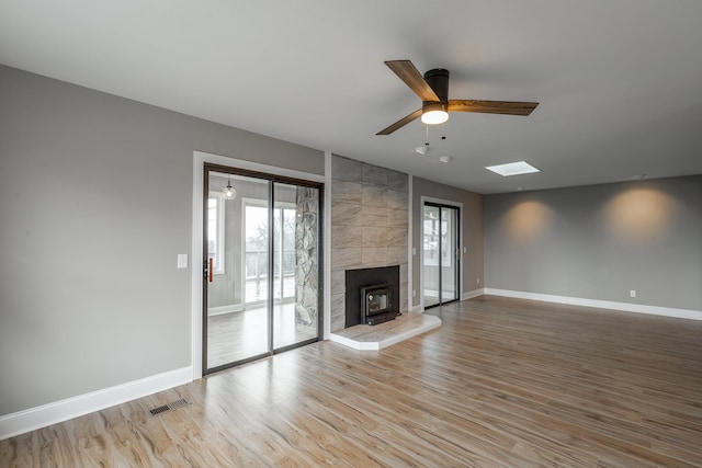 unfurnished living room featuring wood-type flooring and ceiling fan