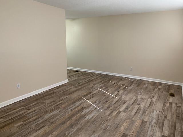 empty room featuring dark hardwood / wood-style floors