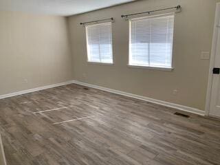 spare room with dark wood-type flooring