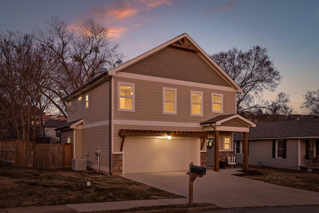 front facade featuring central AC unit and a garage