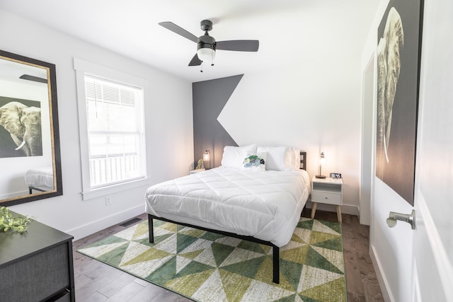 bedroom with wood-type flooring and ceiling fan