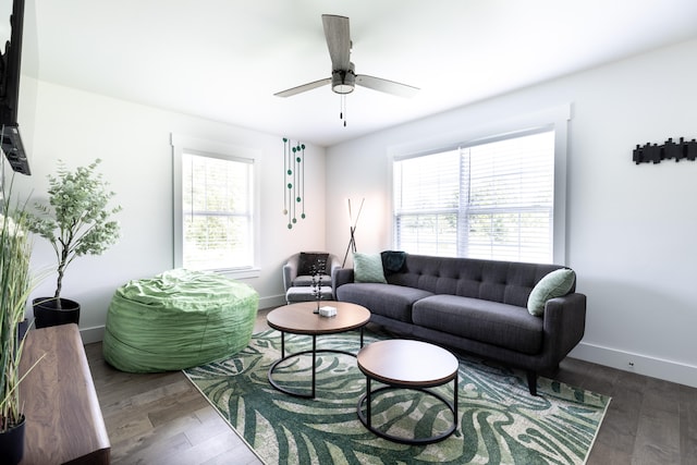 living room with dark wood-type flooring and ceiling fan