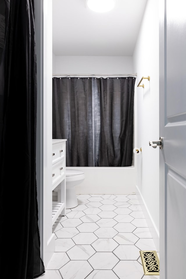 full bathroom with shower / bath combo, vanity, tile patterned floors, and toilet