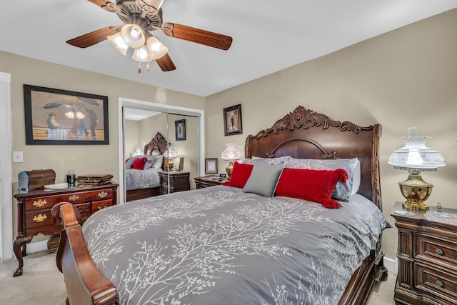 carpeted bedroom with ceiling fan and a closet