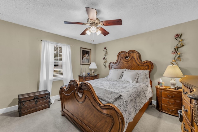 carpeted bedroom featuring a textured ceiling and ceiling fan