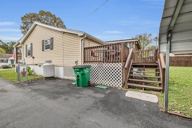 view of side of home featuring a wooden deck