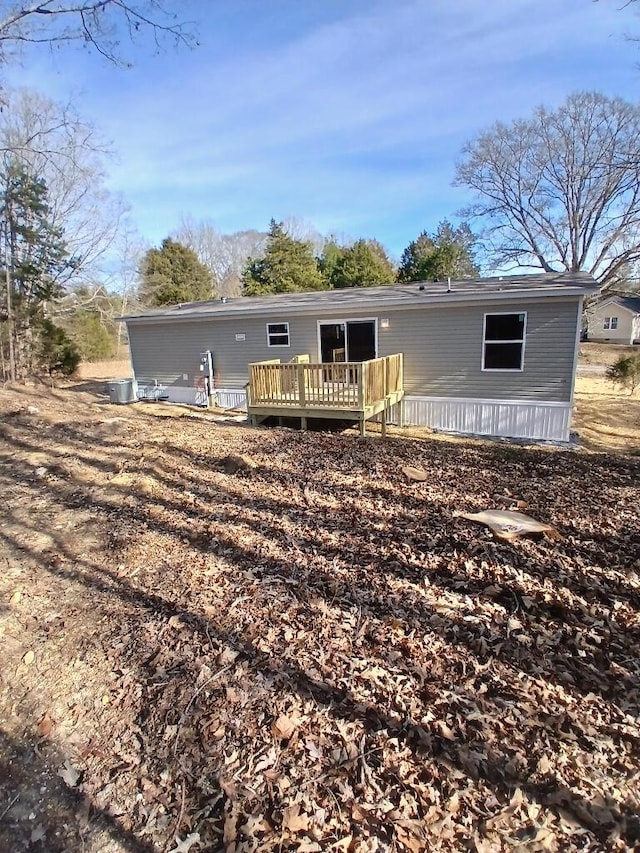 rear view of house with a wooden deck