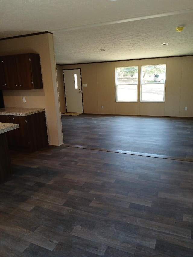 interior space featuring dark hardwood / wood-style flooring and a textured ceiling