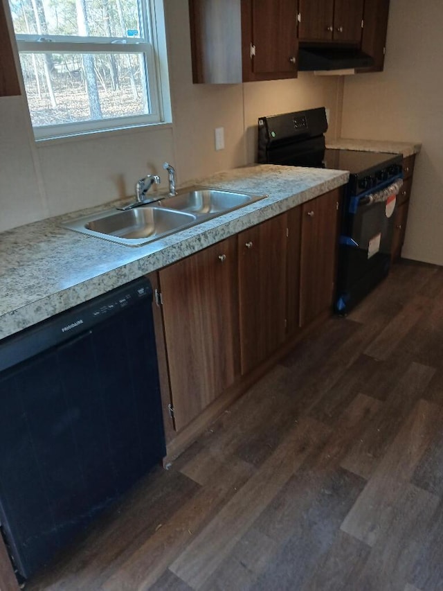 kitchen featuring sink, dark wood-type flooring, and black appliances