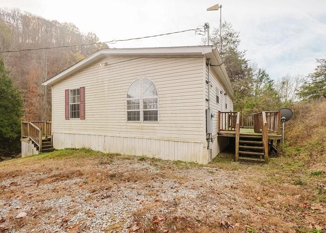 view of property exterior featuring a deck