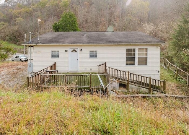 back of house with a wooden deck