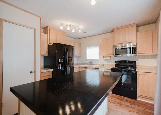 kitchen featuring decorative backsplash, light hardwood / wood-style floors, light brown cabinets, and black appliances