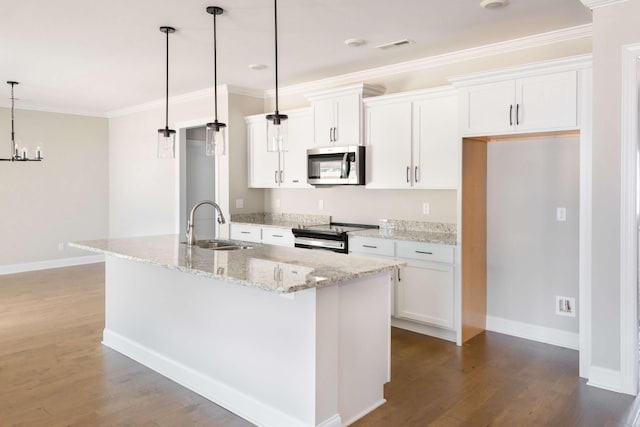 kitchen with appliances with stainless steel finishes, decorative light fixtures, white cabinetry, a kitchen island with sink, and light stone counters