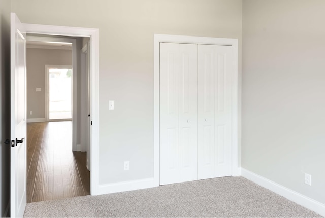 unfurnished bedroom featuring carpet and a closet