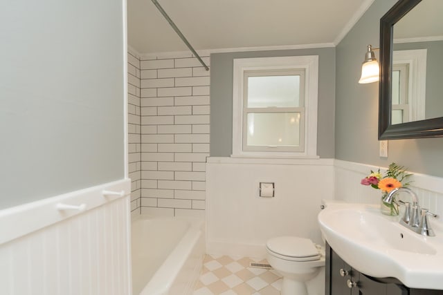 full bathroom featuring vanity, tiled shower / bath, ornamental molding, and toilet