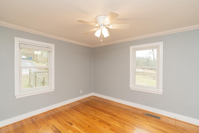 spare room with hardwood / wood-style flooring, ornamental molding, and ceiling fan