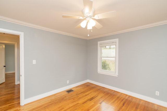 spare room with ornamental molding, ceiling fan, and light hardwood / wood-style flooring