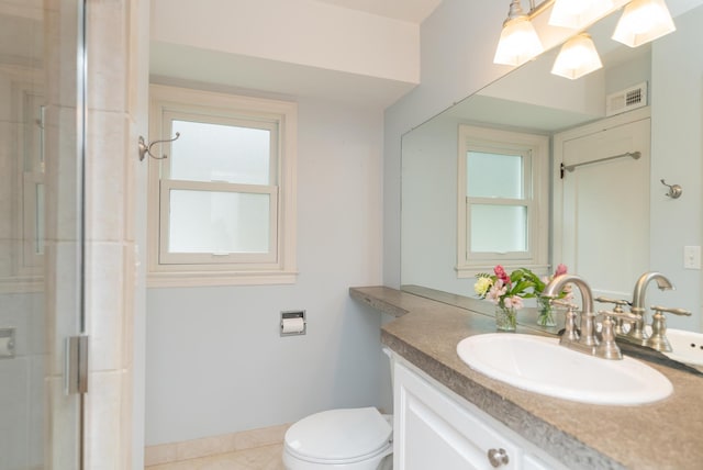 bathroom featuring vanity, toilet, and walk in shower