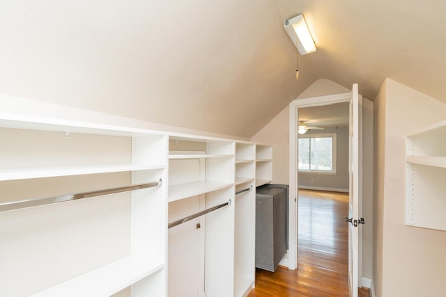 spacious closet featuring lofted ceiling and wood-type flooring