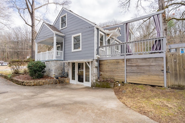 exterior space featuring a wooden deck and ceiling fan