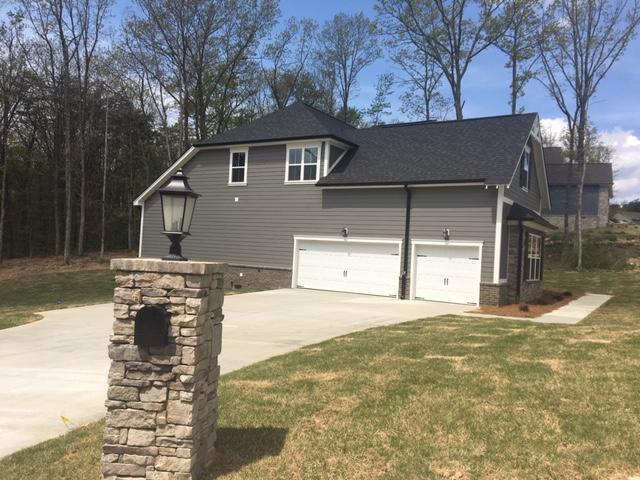 view of side of home with a garage and a yard