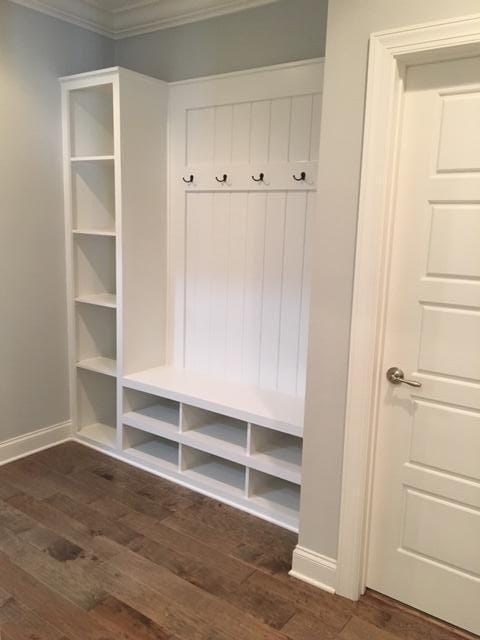 mudroom featuring dark hardwood / wood-style flooring and crown molding