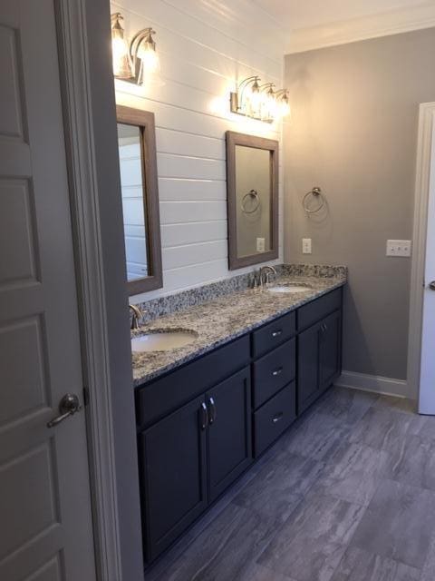 bathroom featuring crown molding and vanity