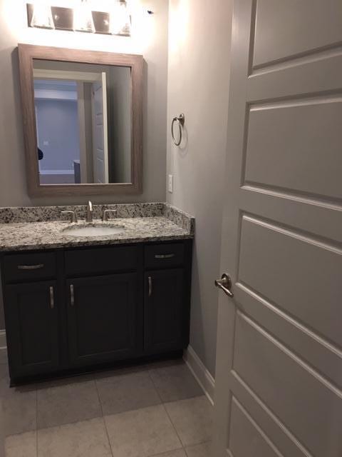 bathroom with vanity and tile patterned flooring