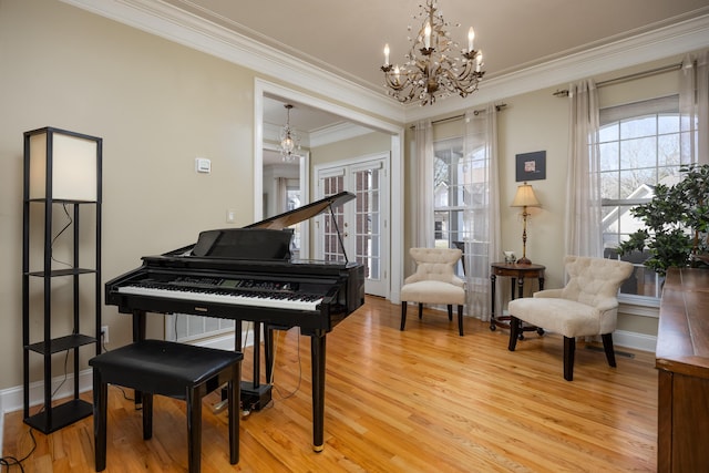 miscellaneous room with crown molding, wood-type flooring, french doors, and a chandelier