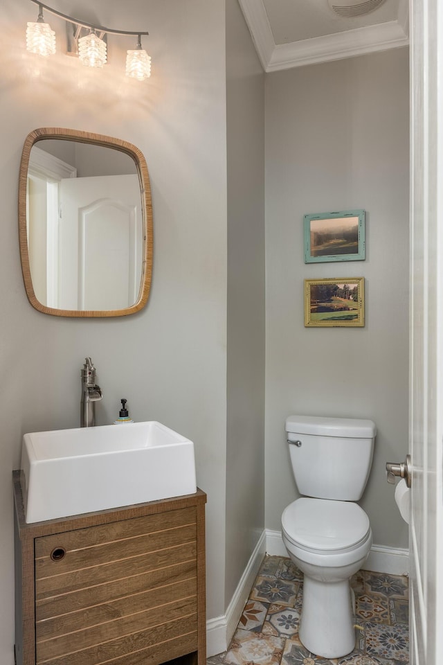 bathroom featuring vanity, crown molding, and toilet