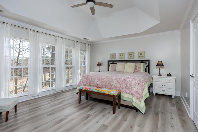 bedroom with ceiling fan, ornamental molding, vaulted ceiling, and light wood-type flooring