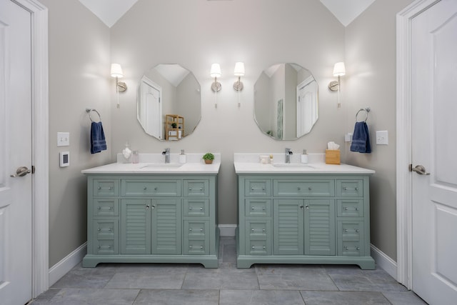 bathroom featuring vanity and lofted ceiling