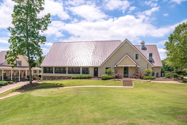 view of front of home featuring a front yard and central air condition unit