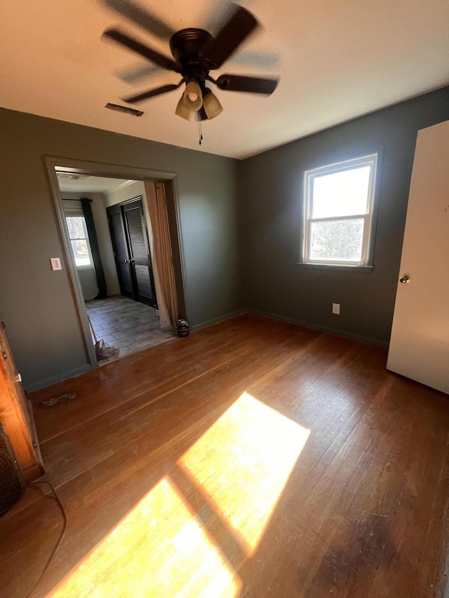 spare room featuring ceiling fan and hardwood / wood-style floors