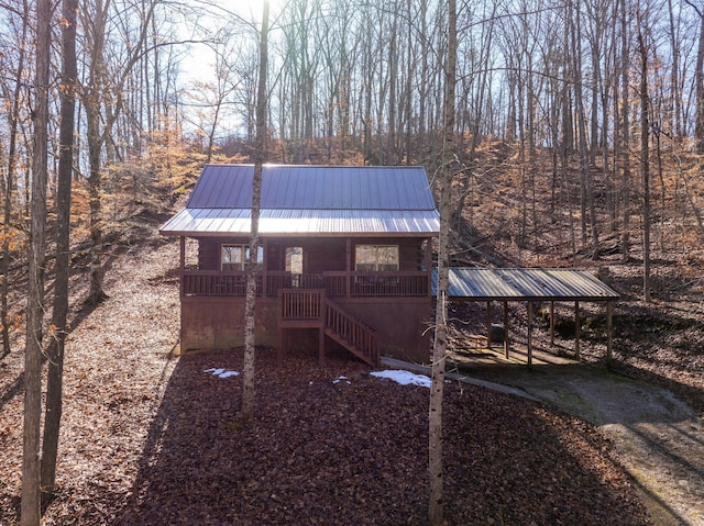 view of outdoor structure with a carport and covered porch