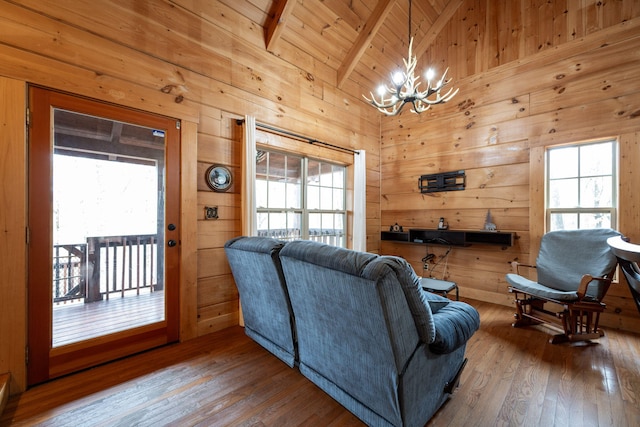 living room with hardwood / wood-style flooring, wooden walls, and wooden ceiling