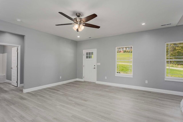 spare room featuring ceiling fan and light hardwood / wood-style floors