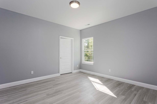 spare room featuring light hardwood / wood-style floors