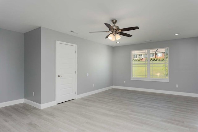 spare room with ceiling fan and light hardwood / wood-style floors