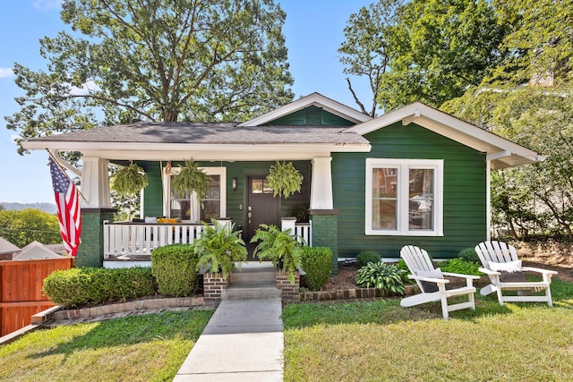 bungalow-style house with covered porch and a front lawn